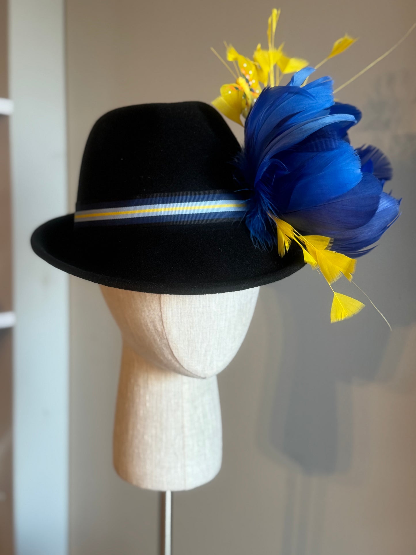 “”Callista” black felt bowler with navy and canary embellishments size57-58cm